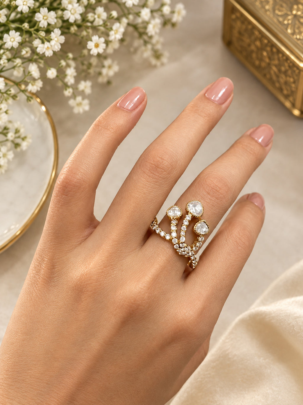 Close-up of Aurveza statement ring featuring three sparkling stones on pave gold band