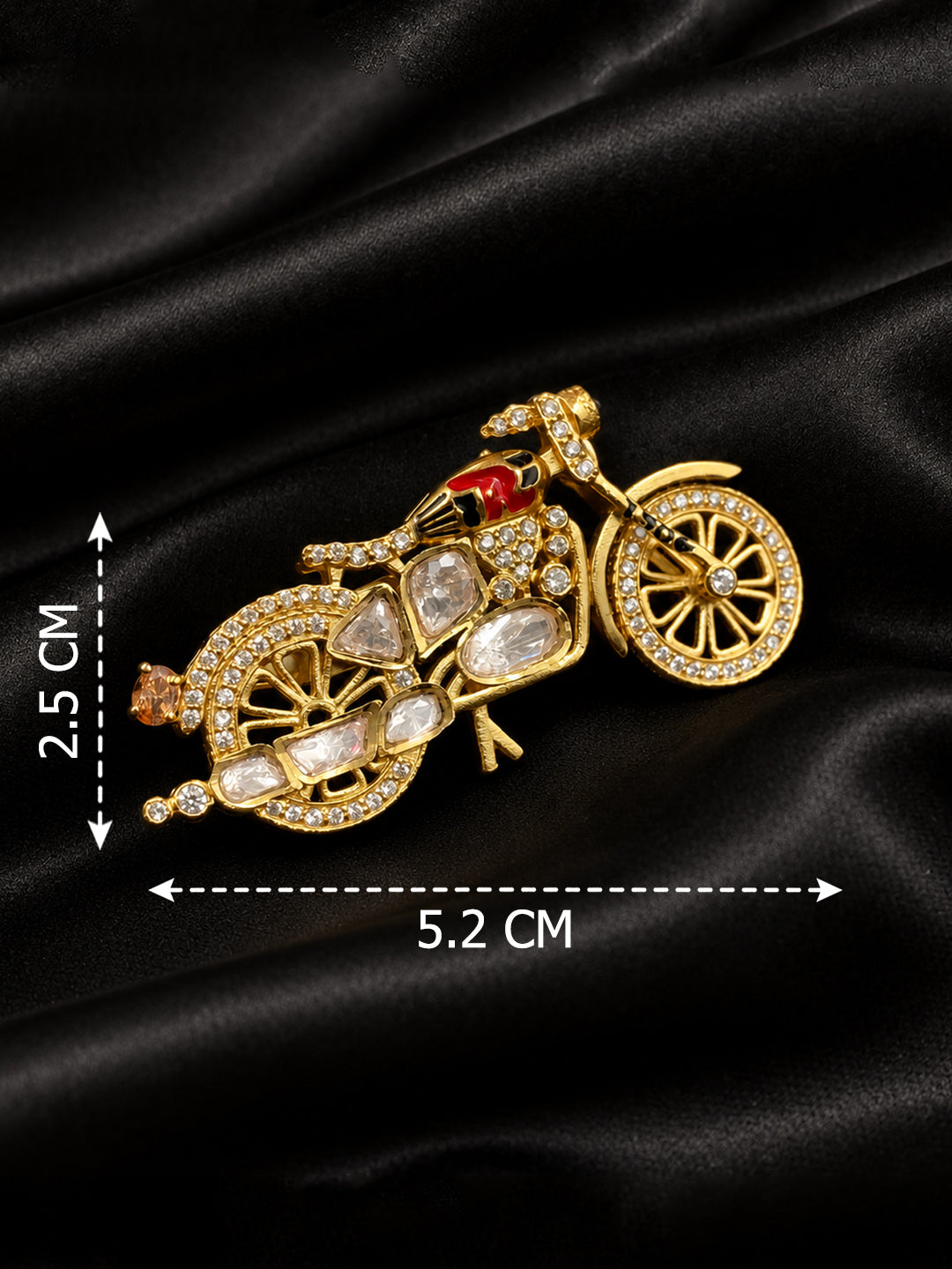 Kundan motorbike brooch with clear polki stones and gold-plated detailing, held in hand